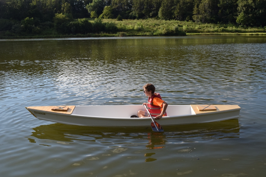 Young man paddling boat.